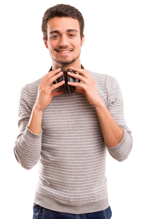Happy young man with headphones on and listening to musicの写真素材