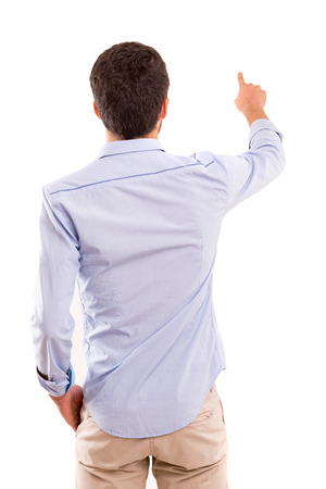 A young man with his back turned to camera, pointing to somethingの写真素材