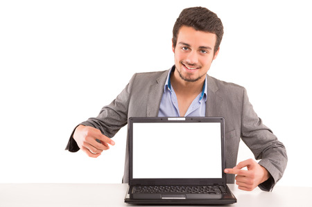 Young man presenting your product in a laptop computerの写真素材