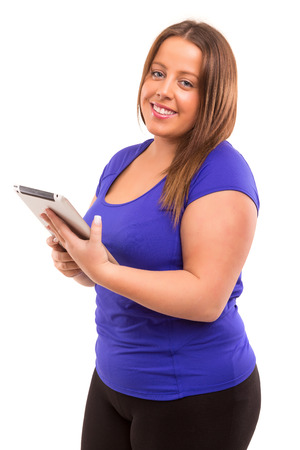 Large fitness woman watching a tablet computerの写真素材