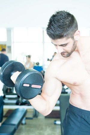 Handsome young man working out at the gymの写真素材