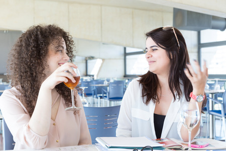 Group of happy students preparing their exams or simply relaxing at a barの写真素材