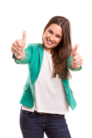 Beautiful young woman signaling ok, isolated over whiteの写真素材