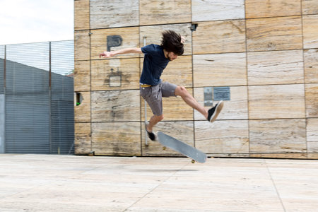 Young boy skateboarder at the local skateparkの写真素材