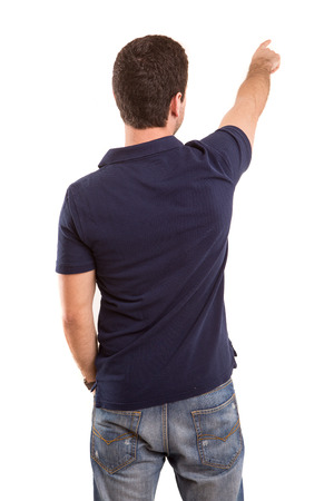 A young man with his back turned to camera, pointing to somethingの写真素材