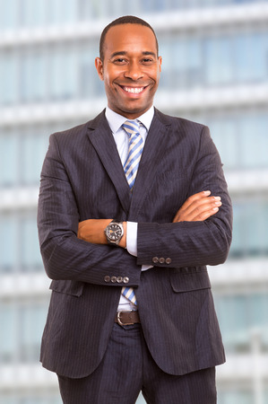 Young handsome african business man posing in front of a modern buildingの写真素材