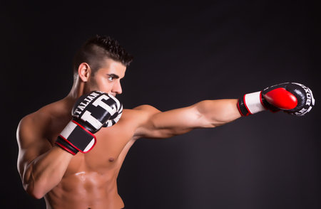 Young kickboxer posing isolated over a copy space background