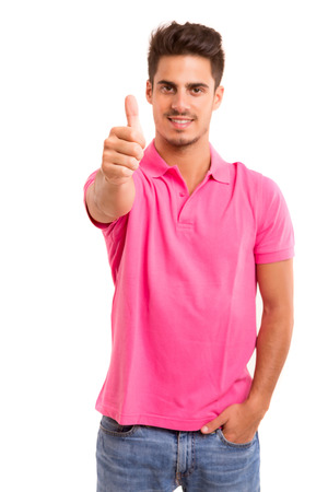 Handsome young man signaling ok, isolated over a white backgroundの写真素材