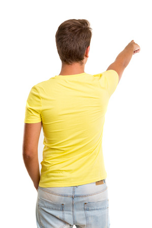 A young man with his back turned to camera, pointing to somethingの写真素材