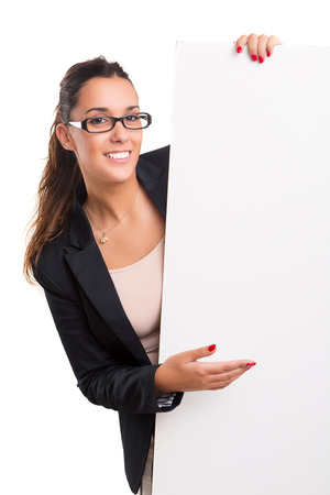 Young business woman presenting your product over a white cardの写真素材