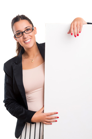 Young business woman presenting your product over a white cardの写真素材