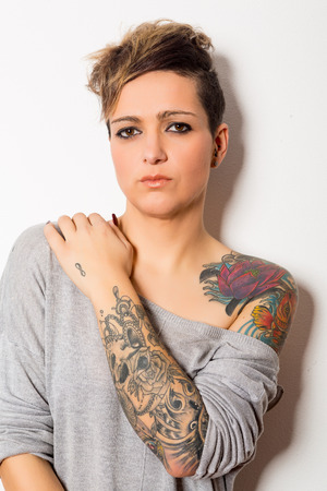 Studio shot of a young tattooed womanの写真素材