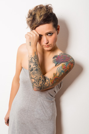 Studio shot of a young tattooed womanの写真素材
