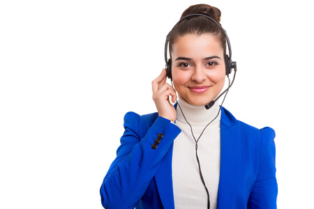 A friendly telephone operator smiling isolated over a white backgroundの写真素材