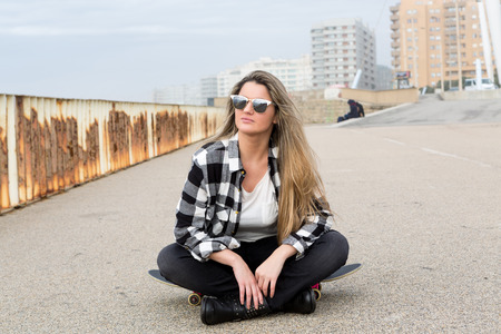 Fashion lifestyle, Beautiful young woman with skateboardの写真素材