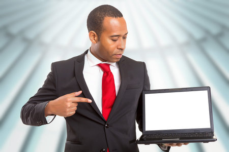 African business man presenting your product in a laptopcomputerの写真素材
