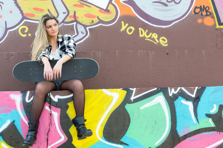 Fashion lifestyle, Beautiful young woman with skateboardの写真素材