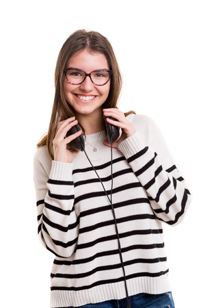 Young woman listening to music, isolated over whiteの写真素材