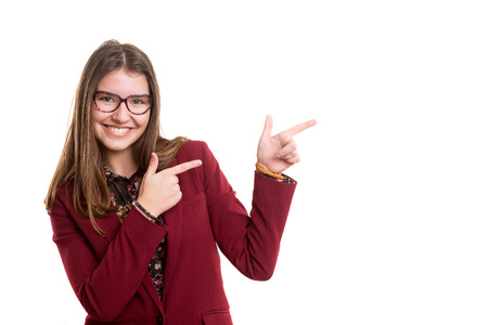 Young beautiful woman presenting your product, isolated over white backgroundの写真素材