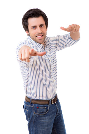 Handsome young man pointing at you, isolated over white backgroundの写真素材
