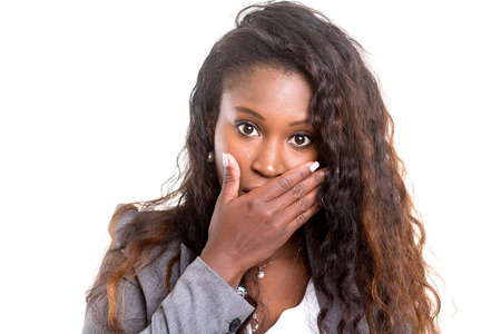 A worried young african woman, isolated over whiteの写真素材
