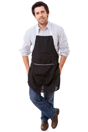 Portrait of handsome young man with apron against white backgroundの写真素材