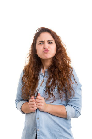 A beautiful young woman making a silly expression, isolated over whiteの写真素材