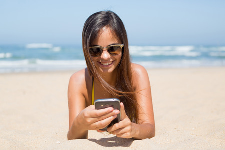 Beautiful young woman relaxing at the beachの写真素材