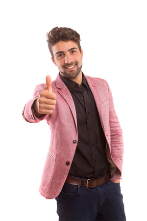 Handsome young man signaling ok, isolated over a white backgroundの写真素材