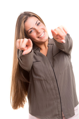 Young beautiful woman pointing at you, isolated over whiteの写真素材