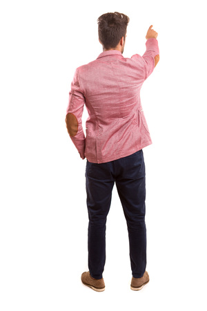 A young man with his back turned to camera, pointing to somethingの写真素材