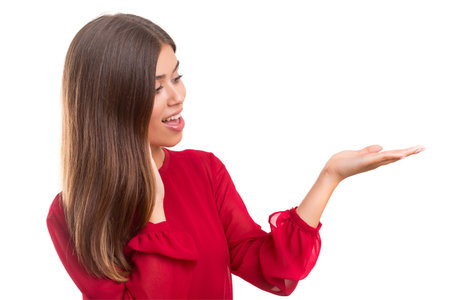 Young beautiful woman presenting your product, isolated over white backgroundの写真素材