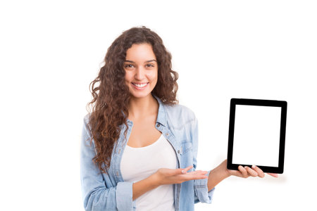 Happy young woman presenting your product in a tablet computerの写真素材