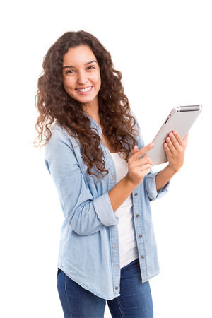 Beautiful woman relaxing with a tablet computerの写真素材