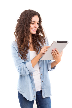 Beautiful woman relaxing with a tablet computerの写真素材