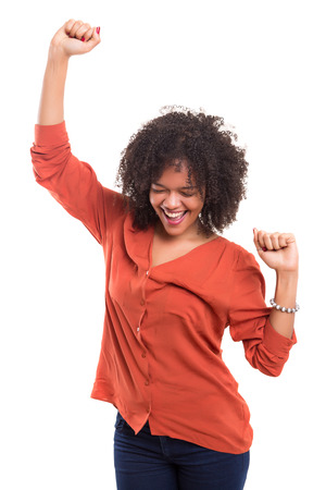 Studio shot: Happy African woman with raised armsの写真素材