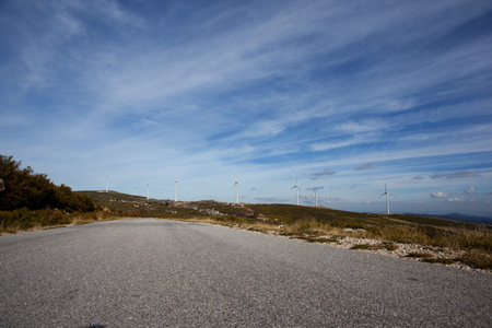 Wind energy turbines, in a landscpae over a beautiful blue sky