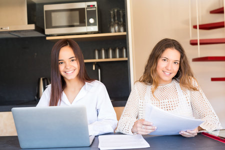 Beautiful young women at home studying for the final exams