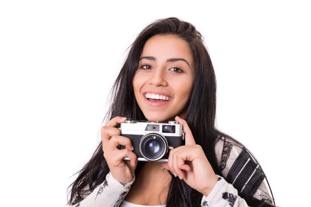 Beautiful woman holding a vintage camera, isolated over white backgroundの写真素材