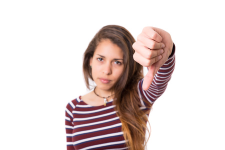 Studio shot of a young woman signaling thumbs downの写真素材