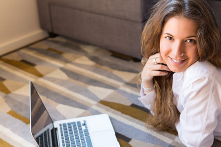Beautiful woman relaxing with a computerの写真素材
