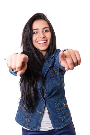 Young beautiful woman pointing at you, isolated over whiteの写真素材
