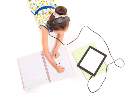 Young girl listening to some music and making a new drawの写真素材