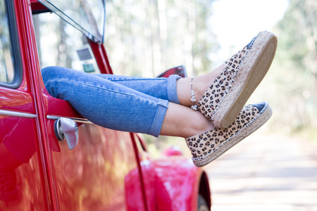 Woman on a roadtrip relaxing in her convertible carの写真素材