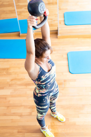Young woman getting into shape with one more training session の写真素材