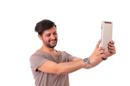 Handsome man relaxing with a tablet computer
