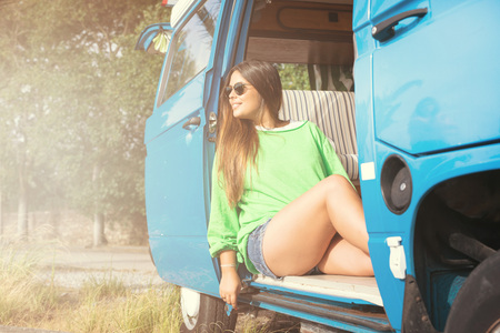 summer holidays, road trip, travel and people concept, young woman resting in minivan carの写真素材