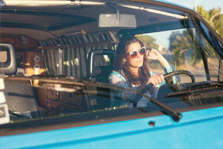 summer holidays, road trip, travel and people concept, young woman resting in minivan carの写真素材