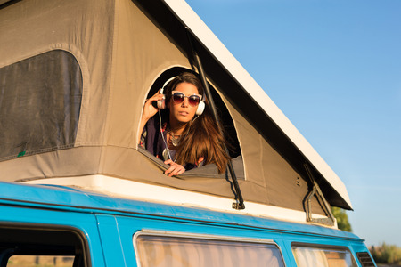 summer holidays, road trip, travel and people concept, young woman resting in minivan carの写真素材
