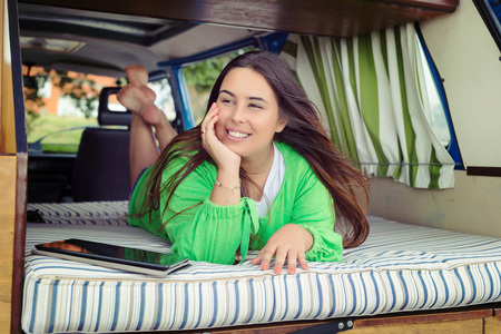 summer holidays, road trip, travel and people concept, young woman resting in minivan carの写真素材